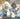 Two poodles in space suits sitting in a car with a license plate 'TOP421'.  Planet Retro NZ