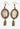 Pair of earrings with vintage-style design on a dark background