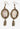 Pair of earrings with vintage-style design on a dark background
