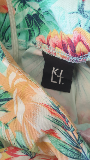 Colorful tropical print fabric with a brand label in the center.