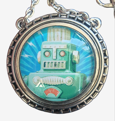 Necklace with a pendant featuring a robot design on a grey background