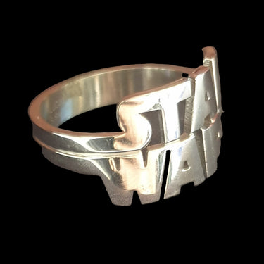 Silver ring with 'STAR WARS' engraving on a dark background