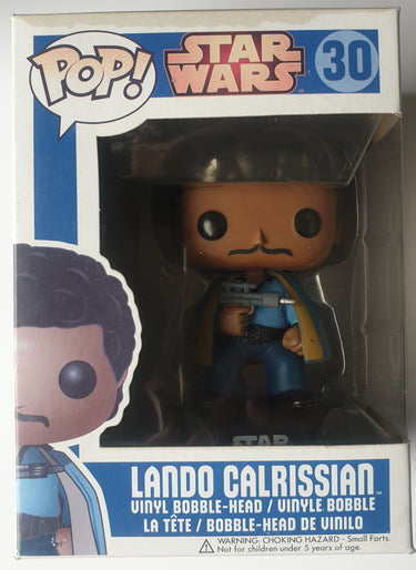 A Funko Pop vinyl figure of Lando Calrissian from Star Wars, with a blue and yellow outfit, holding a blaster. The figure is displayed both in and out of its packaging. Planet Retro NZ.