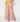 Person wearing a yellow top and floral wide-leg pants on a white background Planet Retro NZ
