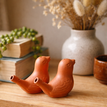 Pair of vintage terracotta bird whistles in unglazed clay, moulded bird form, 7cm long.