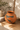 Signed Tomasa Mora Mata Ortiz pottery vessel in reddish terracotta with black geometric decoration.