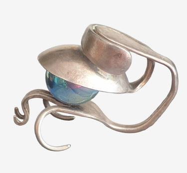 Upcycled EPNS cutlery sculpture featuring an iridescent glass orb in a steampunk-style abstract design.