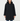 A woman modeling a black hooded coat with a fuzzy dark hood, paired with blue jeans and black ankle boots, against a plain light gray studio background.