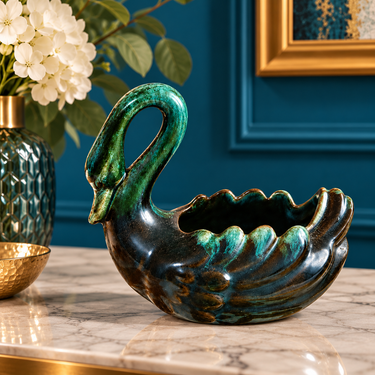 Vintage Blue Mountain Pottery green swan planter styled on marble against a teal blue wall