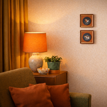 Nostalgic interior with a lamp, plant, and decor on a wall.