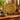 Vintage Peerage brass musicians wall plate, 27cm diameter, displayed on a black stand on a wooden sideboard with antique decor