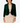 A woman modeling a dark green velvet cropped jacket over a beige dress, standing against a light gray studio background.