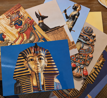 Vintage Tutankhamun artistic postcards spread featuring Egyptian artefacts and gold funerary mask