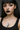 Woman wearing a black tank top and a necklace with a pendant, against a neutral background
